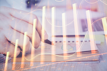 Multi exposure closeup hands with stock market forex graph.