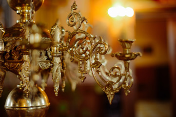Close up of a candle holding chandelier inside a church