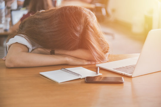 Tired Woman Sleeping On Her Desk