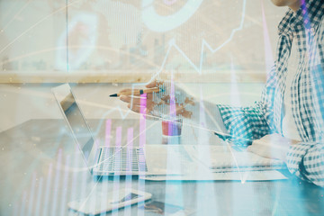 Multi exposure of stock market chart with man working on computer on background. Concept of financial analysis.