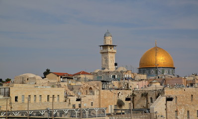 Fototapeta na wymiar View at Temple Mount in Jerusalem, golden cupola of Dome of the Rock, minaret next to, characteristic stony architecture