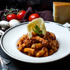 pasta with chicken in tomato sauce and grated cheese