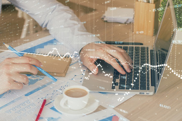 Forex graph with businessman working on computer in office on background. Concept of hardworking. Multi exposure.