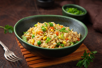 fried rice with vegetables in green bowl
