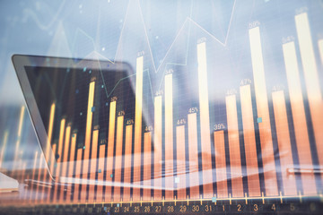 Stock market graph and table with computer background. Double exposure. Concept of financial analysis.
