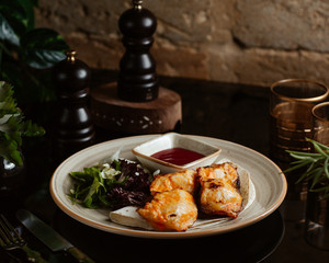 charcoal sturgeon serve with arugula and ketchup