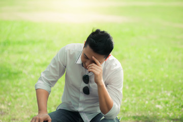 young man feeling serious.young man  siting in the park. 