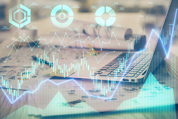 Forex market graph hologram and personal computer on background. Double exposure. Concept of investment.