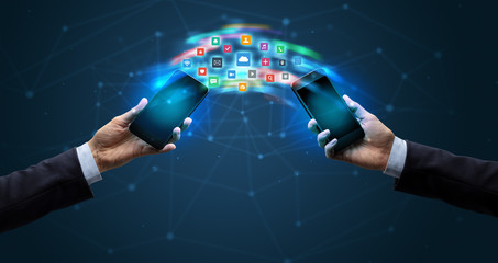 Two mobile phones syncing applications concept