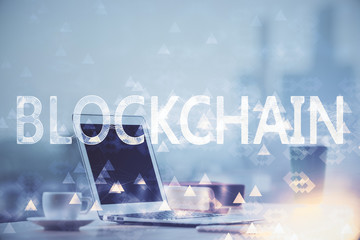 Multi exposure of blockchain theme hologram and table with computer background. Concept of bitcoin...