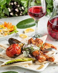 chicken kebab with vegetables on the grill and onions