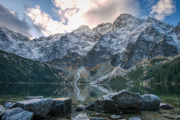 Sea eye in High Tatras with little snow on mountains around , Poland Morskie Oko , tatry - obrazy, fototapety, plakaty