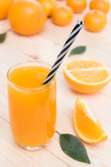 fresh orange juice with orange fruit on wood