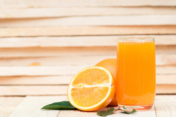 fresh orange juice with orange fruit on wood