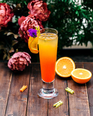 cold orange drink with an orange slice