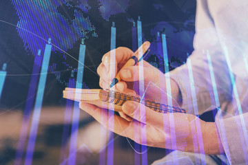 Double exposure hands with stock market chart.