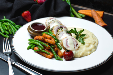 chicken roll in a creamy sauce with vegetables