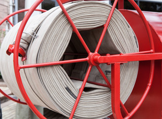 Fire hose on the reel of an old fire truck.