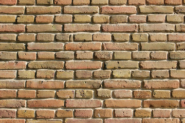 Light yellow and orange brickwork stone wall background texture