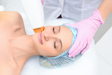 Obraz na płótnie Canvas Anti-aging procedures. Skin care concept. Woman receiving facial beauty treatment, removing pigmentation at cosmetic clinic. Intense pulsed light therapy. IPL. Rejuvenation, photo facial therapy.