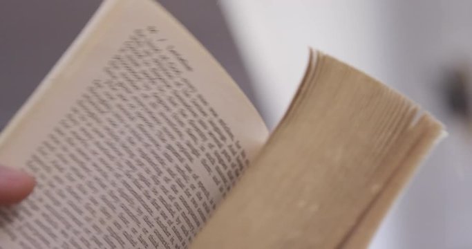 Close Up - An aging book's pages are flipped rapidly - shot on RED