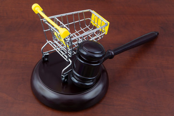 Judge gavel and shopping cart close up, auction concept