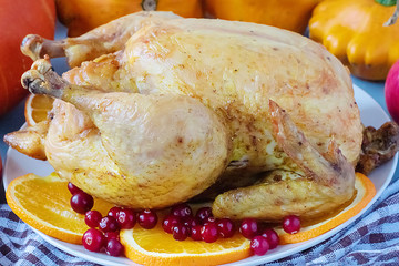 Dish with fried chicken, pumpkin, squash, apples on the kitchen table. Thanksgiving Day