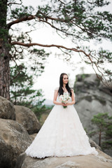 Fototapeta premium Luxury wedding bride, girl posing and smiling with bouquet