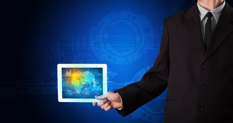 Hand holding tablet with global database concept