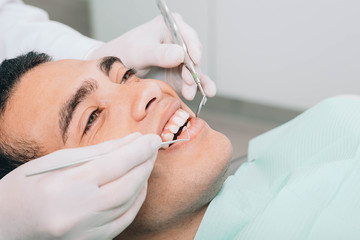 Fototapeta na wymiar African american man check up teeth with dental equipment
