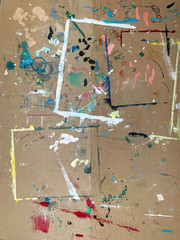 Colourful paintstains on a old cardboard