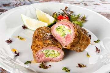 Italian meatloaf on a white plate. Close-up shot