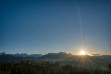 view of High Tatras mountains when they are snowy at sunset on Polish side