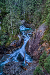 Beautiful waterfall in the mountains with several stairs in autumn, Poland Wodogrzmoty Mickiewicz