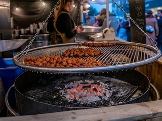 Close focus of traditional Swedish meatballs grilled over coals the traditional way, as demonstrated at a street food stall at the 2019 Christmas market in York