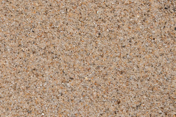 The sand background at the beach near the sea is beautifully arranged in sand