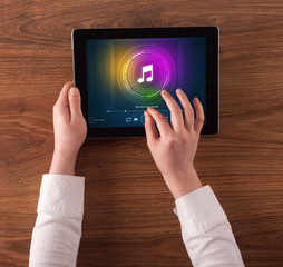Hand touching tablet with music play concept