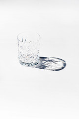 Vintage empty whiskey glass on white background.