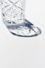 Vintage empty whiskey glass on white background.