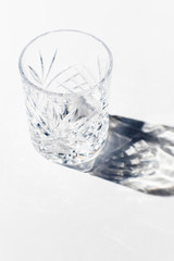 Vintage empty whiskey glass on white background.