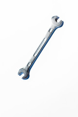 Open end chrome wrench on white surface.