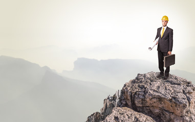 Young business person on the top of the rock