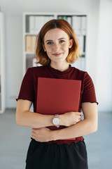 Smart young job applicant clutching her CV