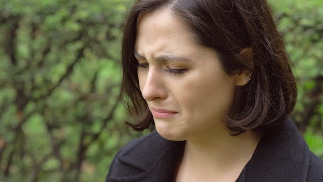 desperate sad lonely young woman crying in the park. Love problems, crisis