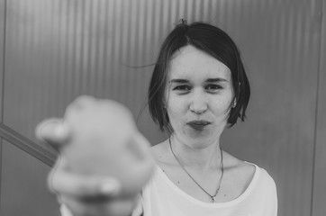 Black and white shot of Cute girl eating fresh lemon.