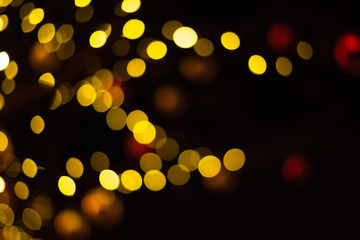 Christmas lights with highlights sparkles on a dark background. Out of focus, blues. Festive atmosphere of lights in the night.