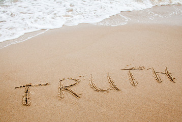 Word truth written on the sand