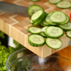 Cook holds knife in hand and cuts on