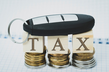 tax on auto, car key and coins the concept of taxation of transport