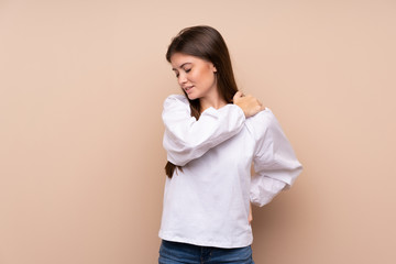 Young girl over isolated background suffering from pain in shoulder for having made an effort